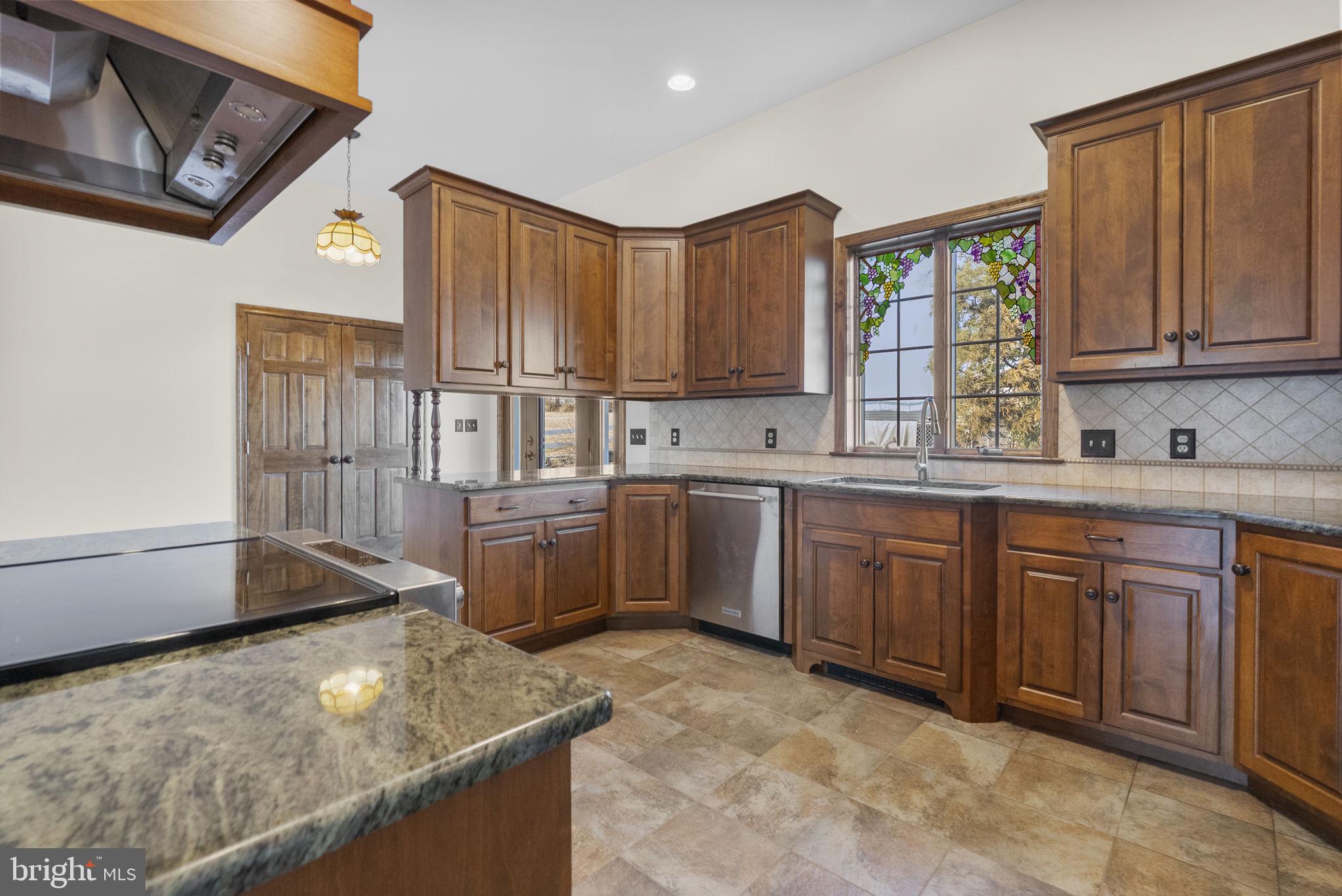 185 Spring Hollow Road Spring City, PA 19475 - Photo 16 of 33 a kitchen with stainless steel appliances granite countertop a sink stove and cabinets