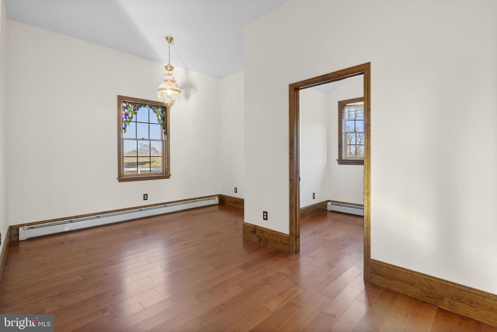 185 Spring Hollow Road Spring City, PA 19475 - Photo 19 of 33 an empty room with wooden floor and windows