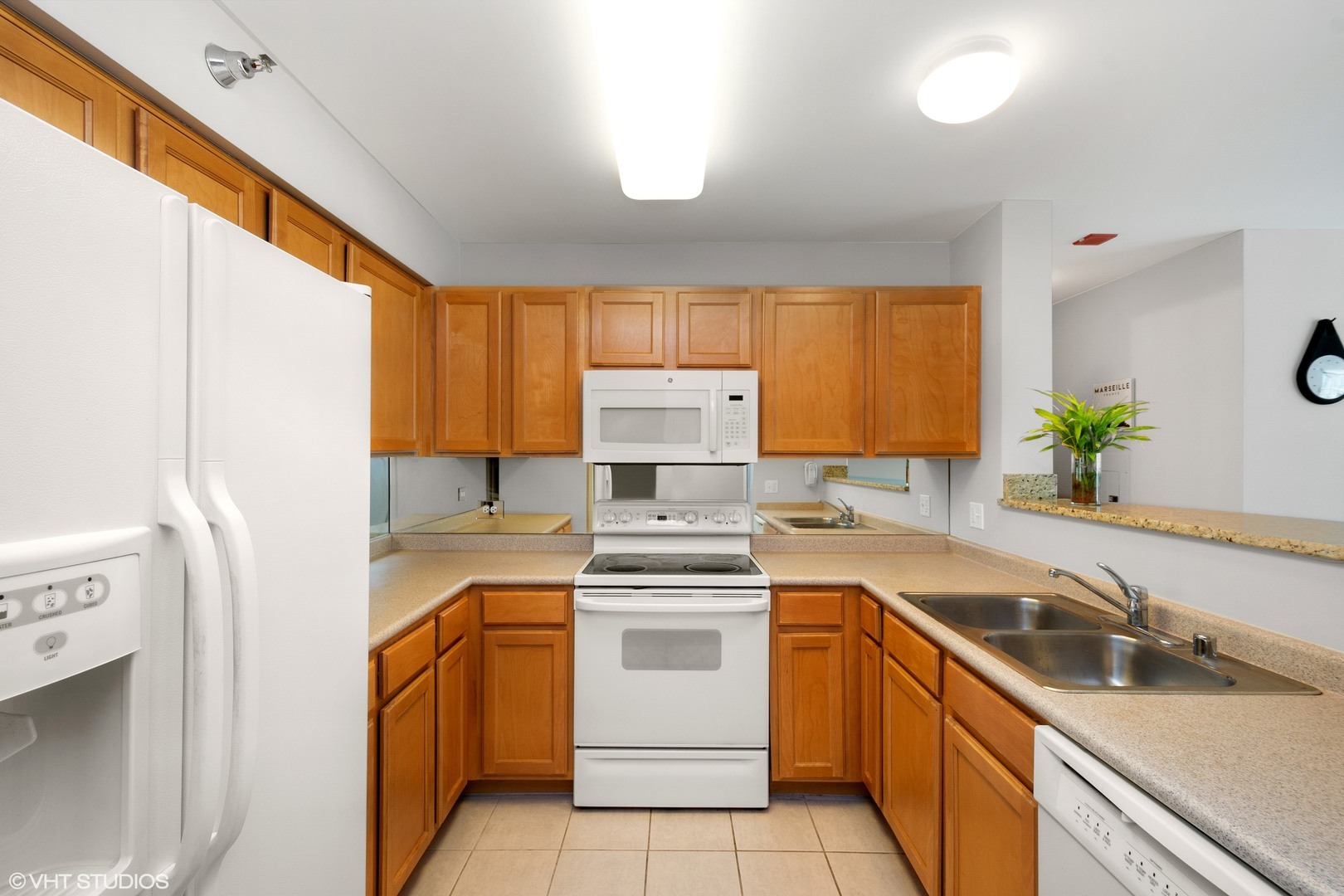 345 North LaSalle Drive, Unit 2505 Chicago, IL 60654 - Photo 3 of 16 a kitchen with a sink stove and refrigerator