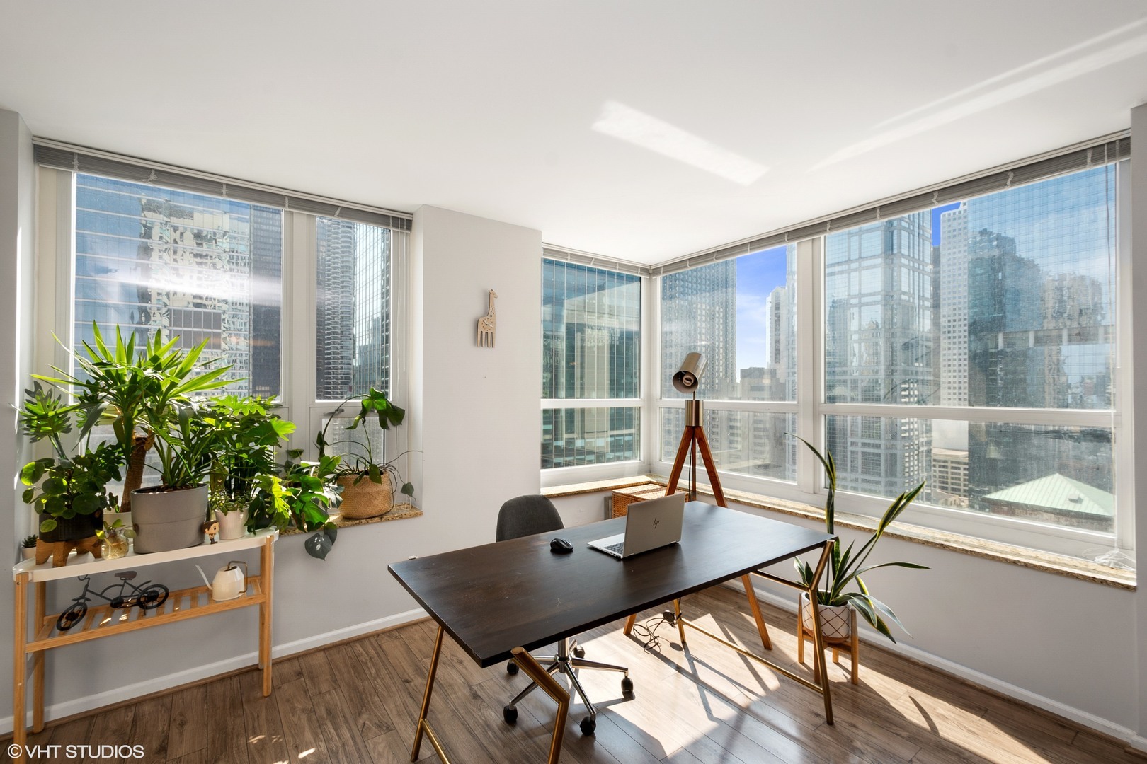 345 North LaSalle Drive, Unit 2505 Chicago, IL 60654 - Photo 6 of 16 a living room with furniture and a potted plant