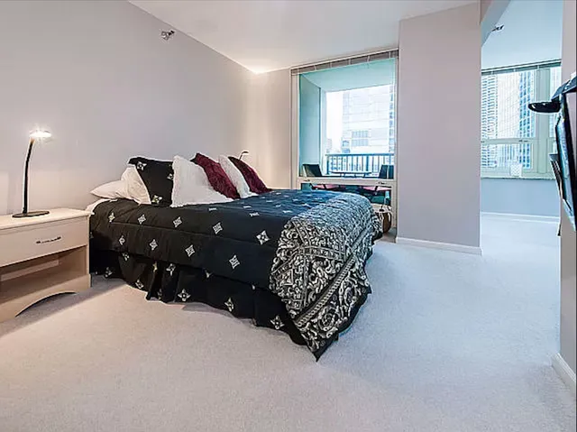 a bedroom with a bed and window