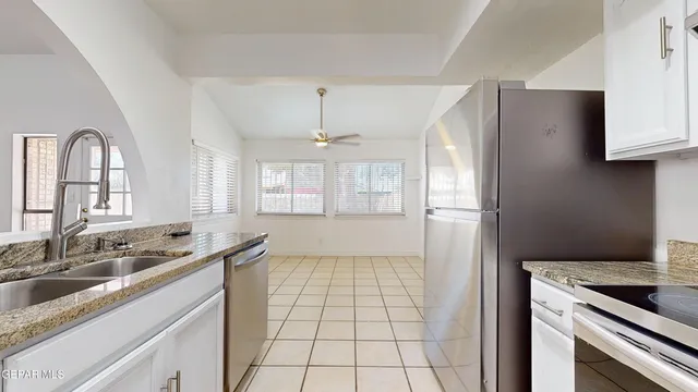 a view of a kitchen with a sink and refrigerator