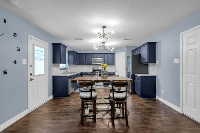 a view of a dining room with furniture and window