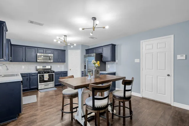 a view of a dining room with furniture and wooden floor