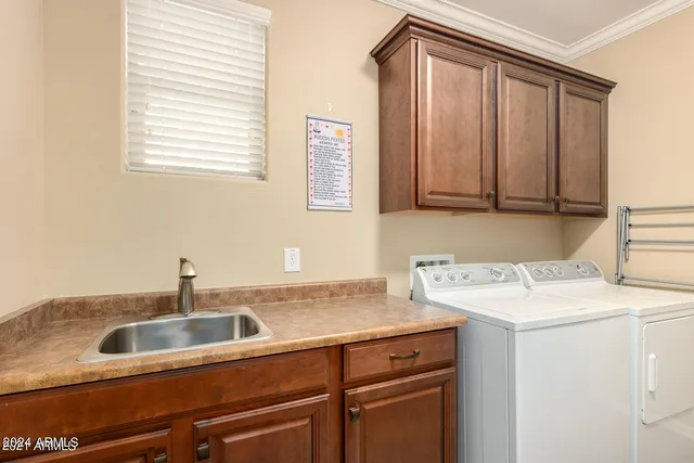 a kitchen with a sink cabinets and a window