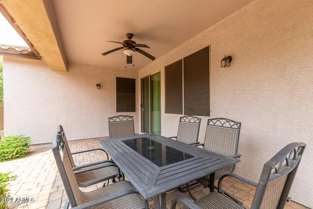 a view of a patio with a table and chairs