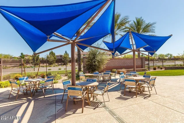 a view of a patio with a table and chairs under an umbrella