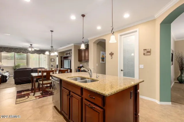 a kitchen with center island and stainless steel appliances