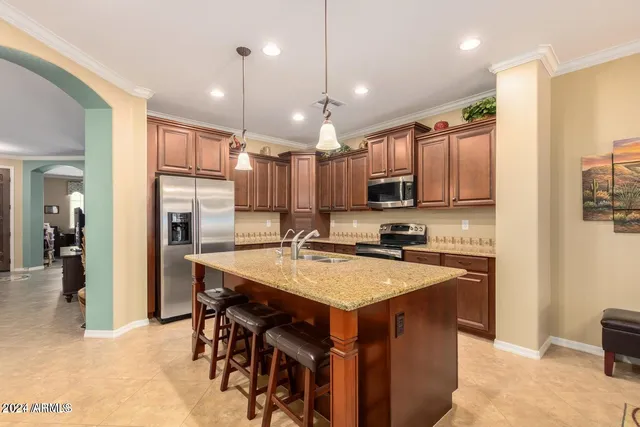 a open kitchen with stainless steel appliances granite countertop a sink refrigerator and cabinets