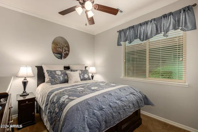 a bedroom with a large bed and a window