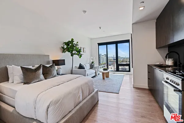a spacious bedroom with a bed and a cabinets