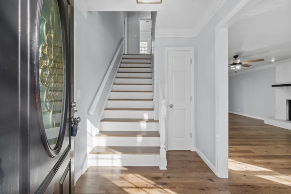 a view of a livingroom with wooden floor and entryway