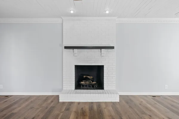 a living room with a fireplace and a fireplace