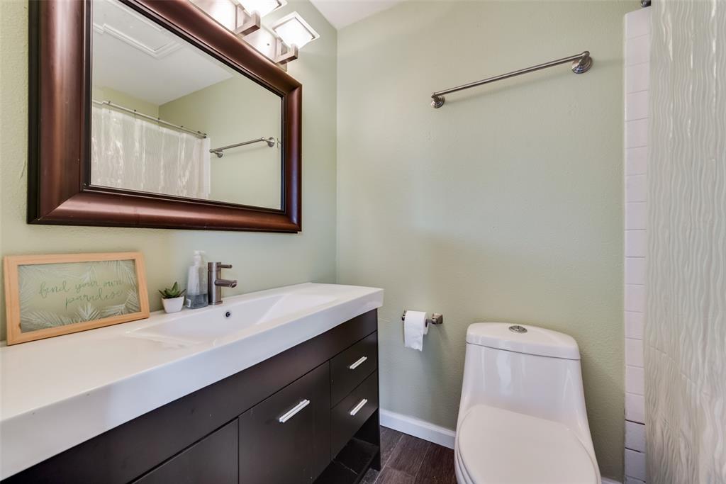 2652 Entrada Boulevard Irving, TX 75038 - Photo 19 of 28 a bathroom with a toilet sink and mirror