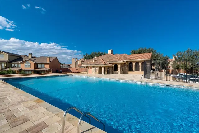 a view of a house with pool and a yard