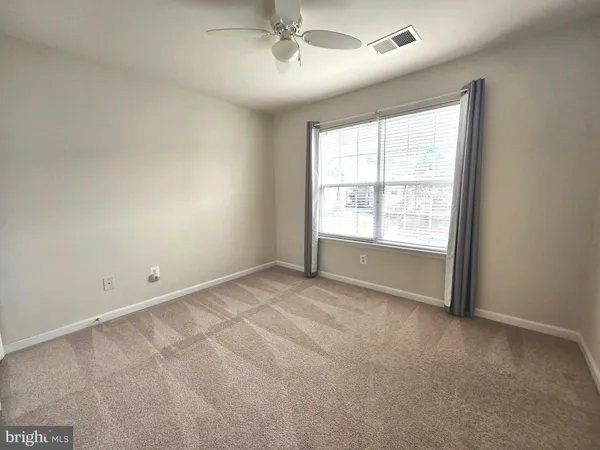 an empty room with a empty space and windows