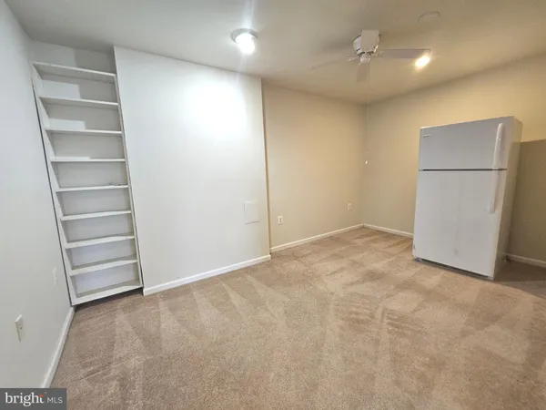 a view of an empty room with a kitchen
