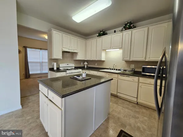 a kitchen with a sink stove and refrigerator