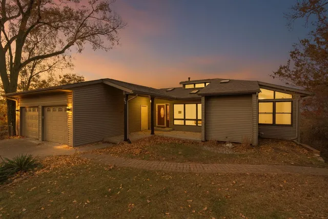 a view of a house with a large tree