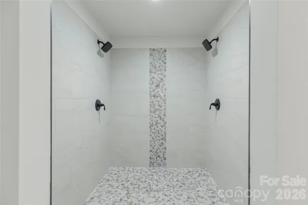 a view of a room with wooden floor and windows