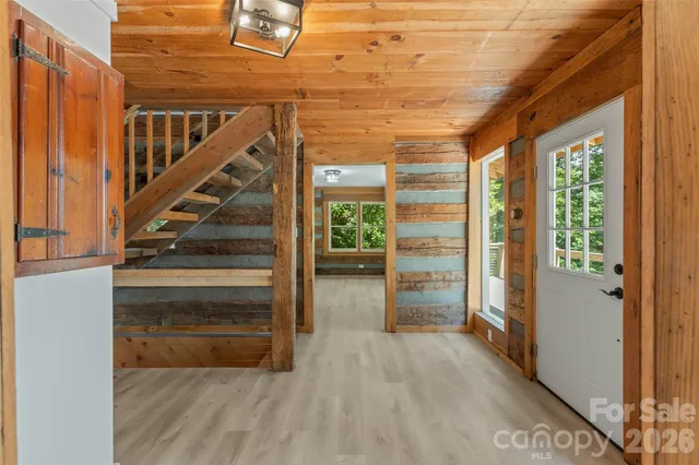 a view of entryway and hall with wooden floor