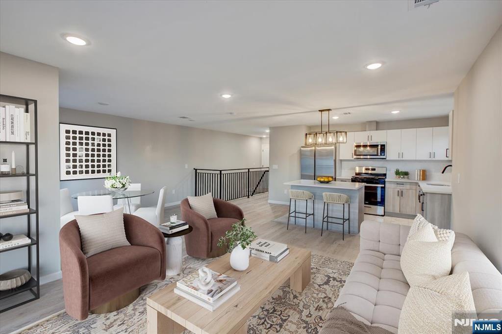 581 Bergen Street Newark, NJ 07108 - Photo 5 of 30 a living room with furniture and kitchen view