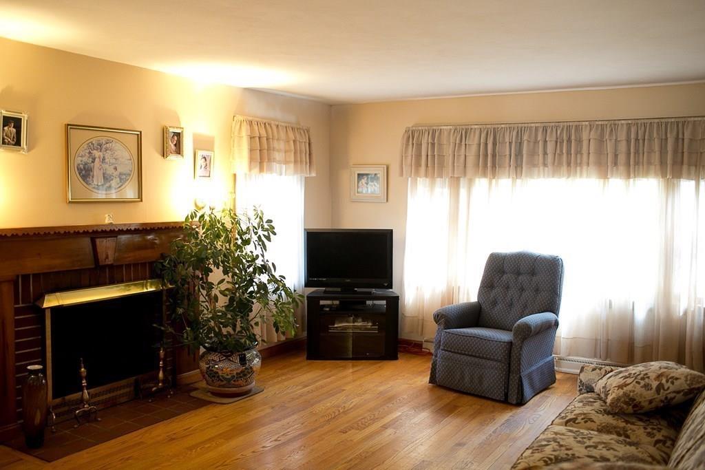 280 Harkness Avenue Springfield, MA 01118 - Photo 19 of 36 a living room with furniture flat screen tv and a fireplace