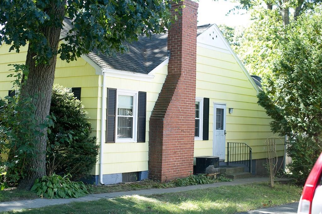 280 Harkness Avenue Springfield, MA 01118 - Photo 3 of 36 a view of a white house next to a yard with big trees