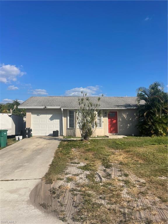 1756 52nd Terrace Southwest Naples, FL 34116 - Photo 2 of 18 a front view of a house with a yard and garage