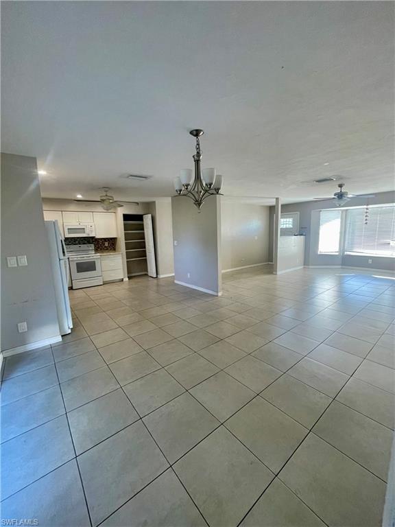 1756 52nd Terrace Southwest Naples, FL 34116 - Photo 7 of 18 a view of a kitchen with furniture and an empty room