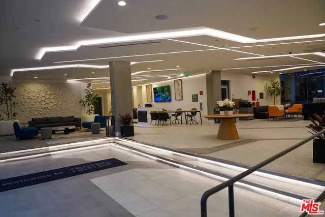 a lobby with furniture and a gym equipment