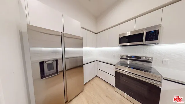 a close view of a refrigerator a washer and dryer