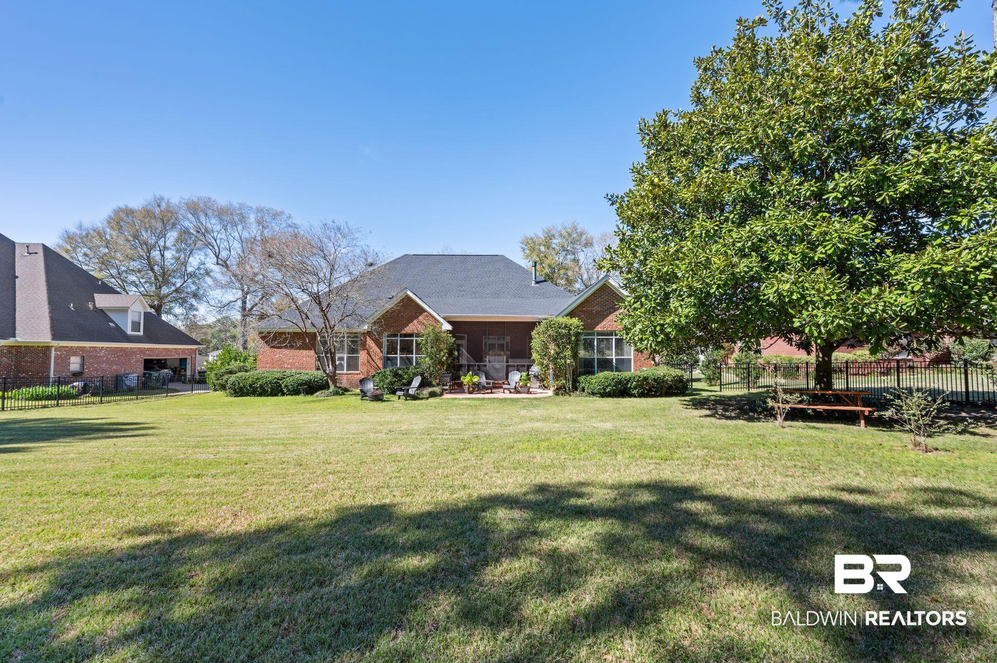 30151 Dolive Ridge Daphne, AL 36527 - Photo 27 of 37 Exterior space featuring brick siding, a lawn, and fence