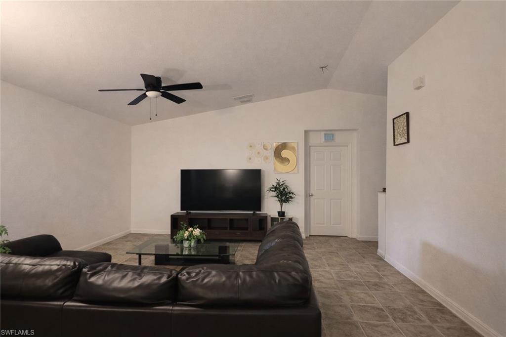 2275 Robin Drive Naples, FL 34117 - Photo 12 of 15 Living room with vaulted ceiling and ceiling fan