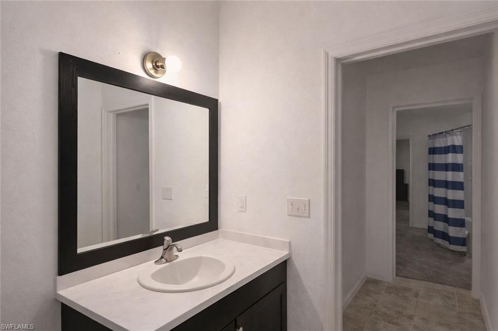 2275 Robin Drive Naples, FL 34117 - Photo 7 of 15 Full bath featuring vanity and a shower with shower curtain