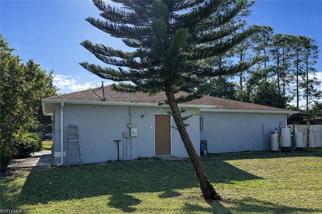 2275 Robin Drive Naples, FL 34117 - Photo 10 of 15 Back of property featuring stucco siding