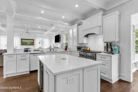 a kitchen with white cabinets and white appliances