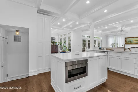 a kitchen with white cabinets and white appliances