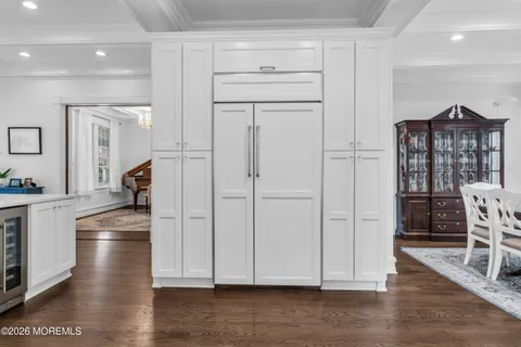 a kitchen with granite countertop a refrigerator and a sink
