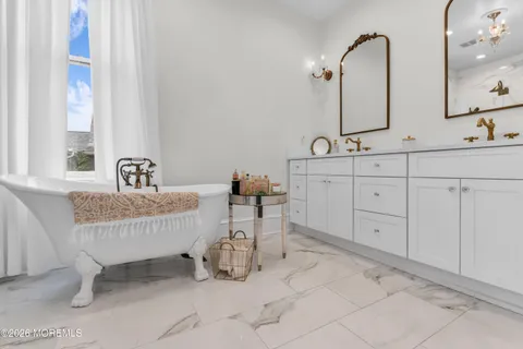 a bathroom with double vanity sinks and a mirror