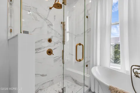 a view of walk in closet with clothes