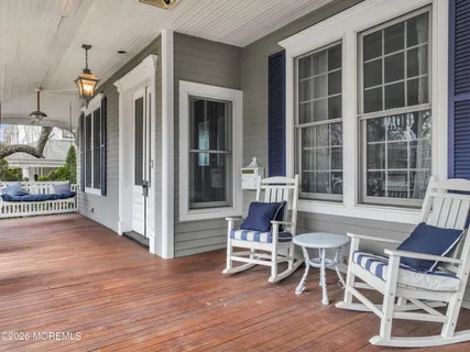 a view of a porch with a table and chairs