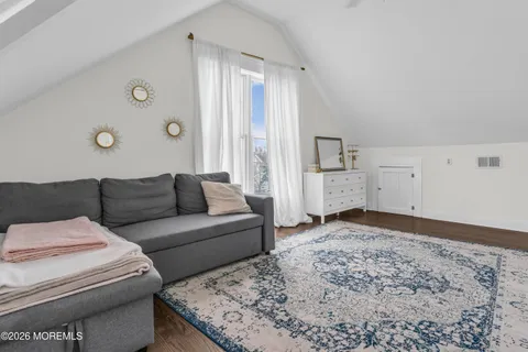 a view of a chair and tables in the balcony