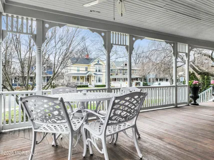 a view of a chairs and table in the balcony