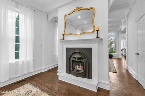 a view of a livingroom with a fireplace and window