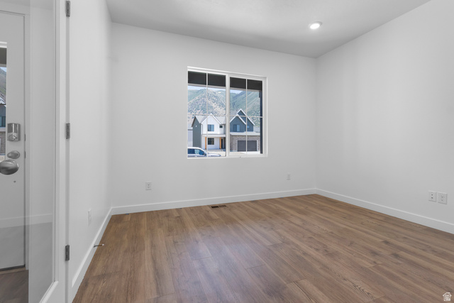 1355 West 2350 South, Unit 11 Perry, UT 84302 - Photo 14 of 39 Room featuring wood-finish flooring, recessed lighting, and a window with mountain scenery