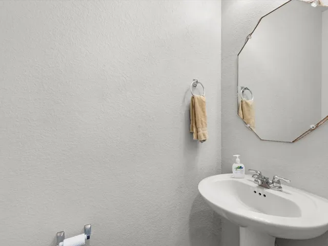 a bathroom with a sink and mirror