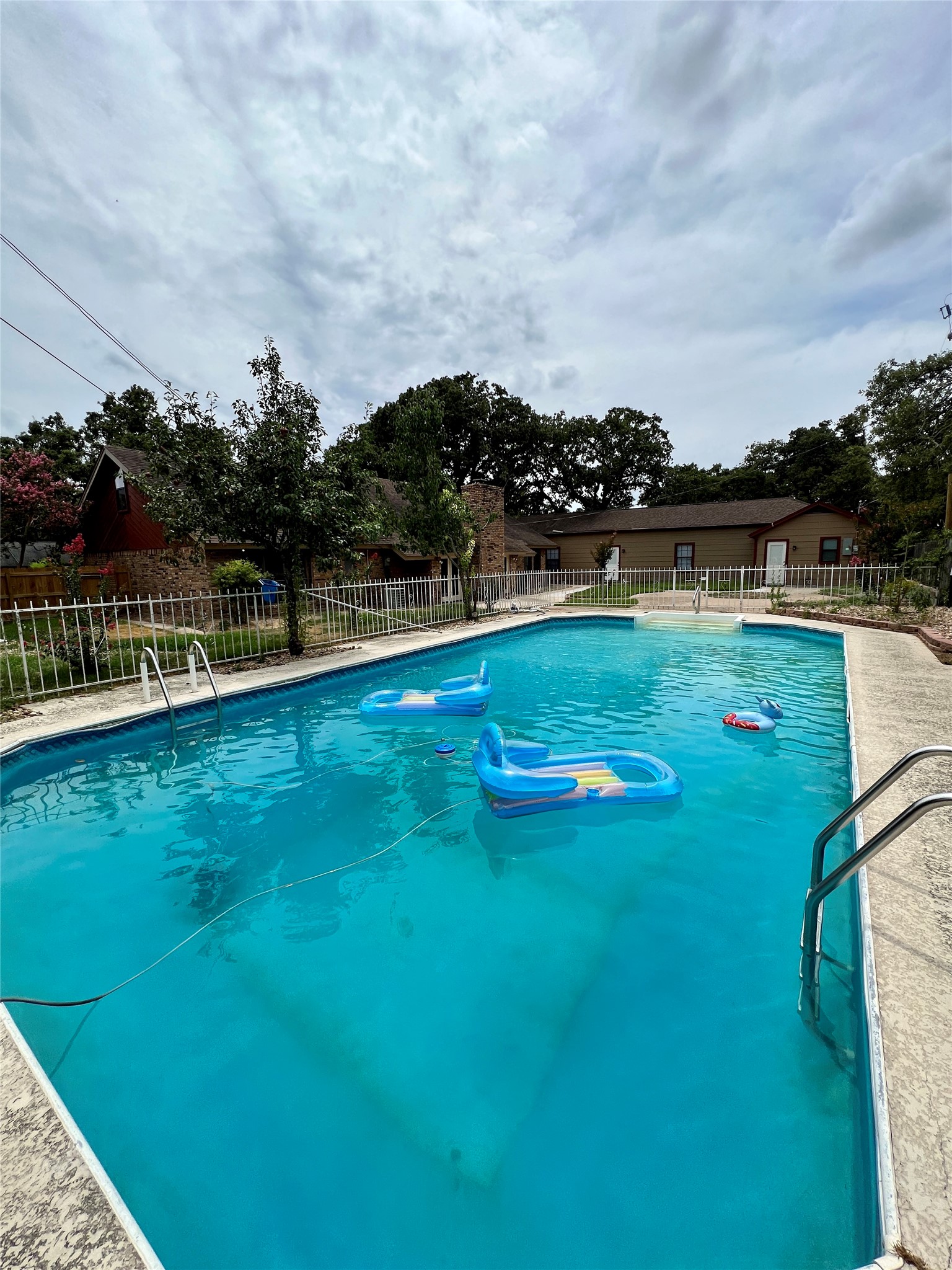1602 Yokley Road Rockdale, TX 76567 - Photo 11 of 40 a view of swimming pool with lawn chairs and wooden fence