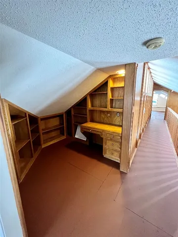 a view of an empty room with window and fireplace