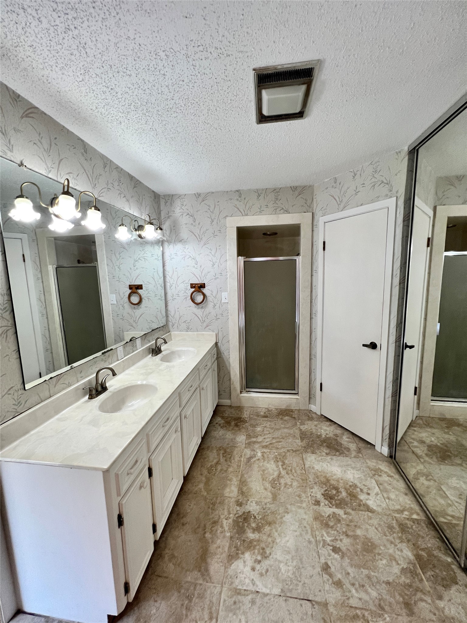 1602 Yokley Road Rockdale, TX 76567 - Photo 25 of 40 a spacious bathroom with a double vanity sink and a mirror